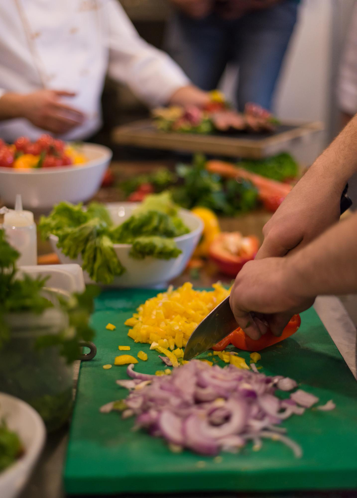 chef-cutting-fresh-delicious-vegetables-cooking-salad